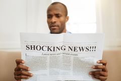 o-american-man-holding-newspaper-reading-106380599.jpg
